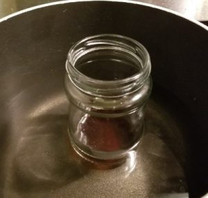 Melt the decarbed shatter into heated coconut oil to make canna honey tincture recipe.